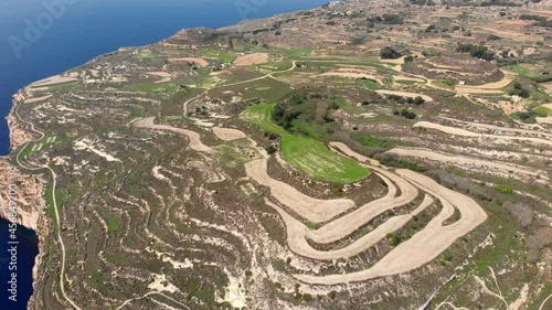 Pretty aerial drone video from west of Malta, Dingli, Ras id-Dawwara surroundings from the sky in the middle of the day. photo