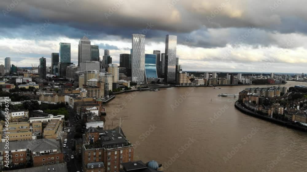 Aerial view of stormy dark clouds over Canary Wharf, approaching London financial District at sunset Aerial view of stormy dark clouds over Canary Wharf, approaching London financial District at sunset