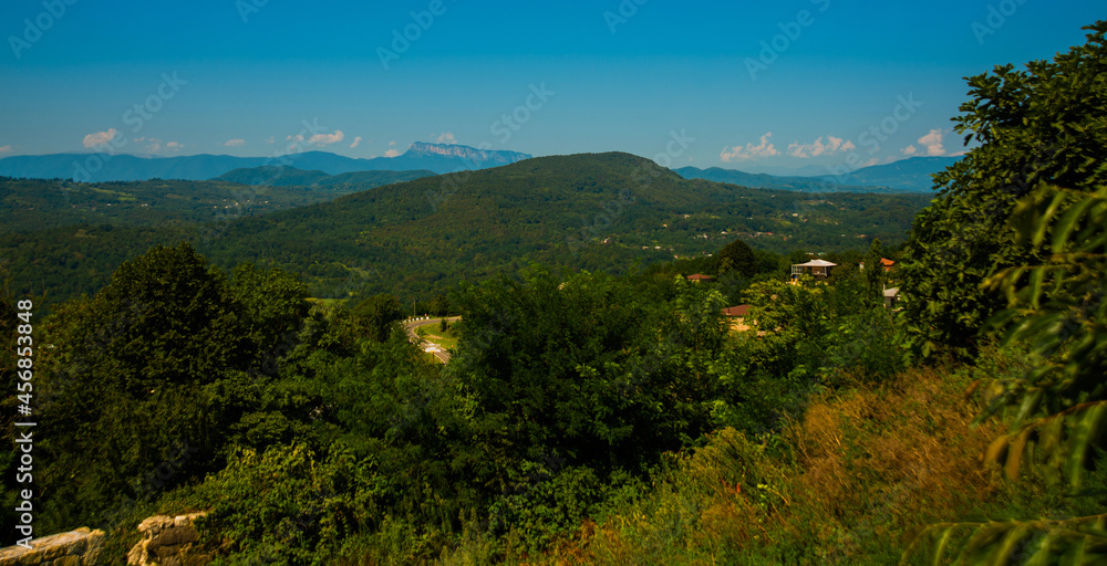 KUTAISI, GEORGIA: Beautiful landscape with views of the hills and mountains in Gelati Monastery on a sunny summer day.