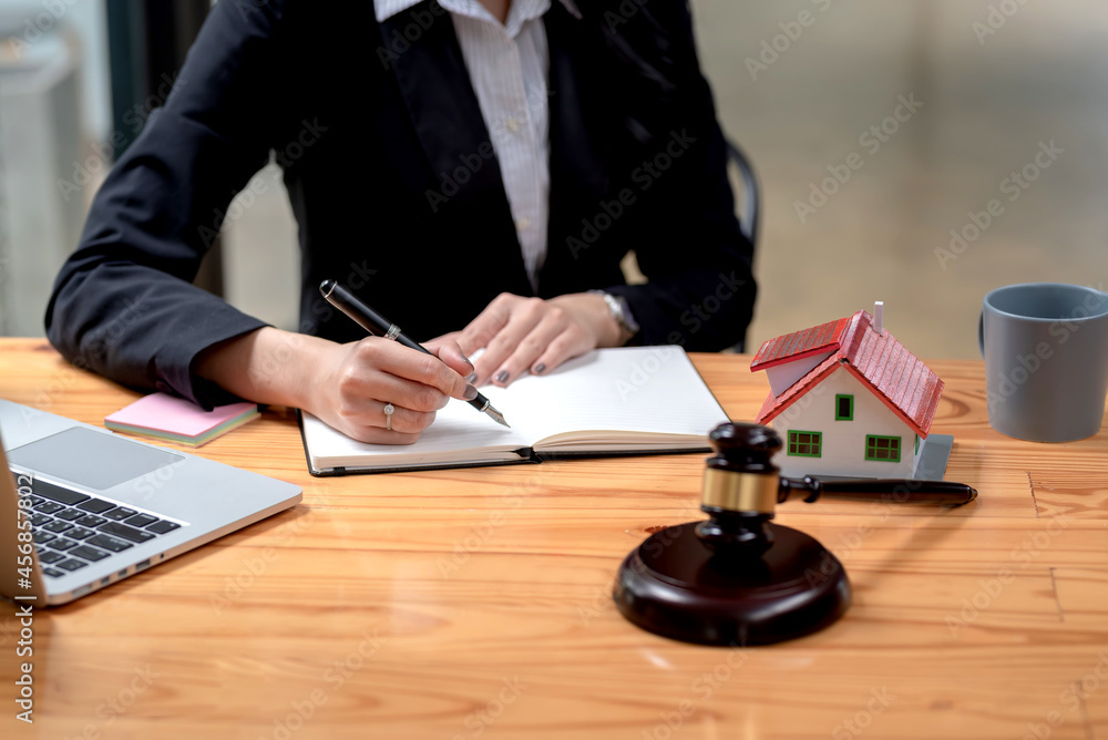 Closeup of a woman lawyer holding a pen and taking notes on a sample