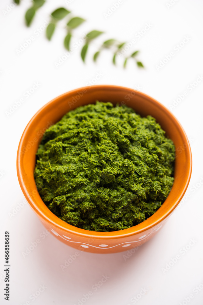 curry leaves or kadi patta chutney in a bowl curry leaves or kadi patta chutney in a bowl