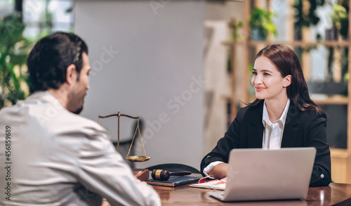 female lawyer smiles and gives legal advice to clients who come to consult