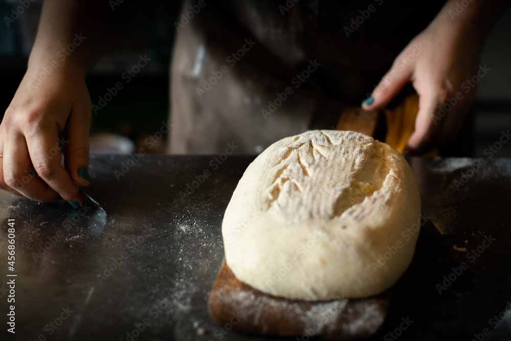 Girl baker cuts bread blank blade Girl baker cuts bread blank blade