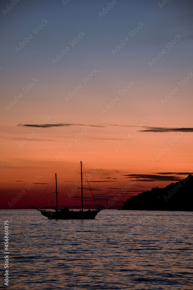 schooner with sunset over the sea