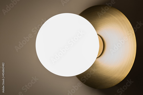 Brass wall light with frosted globe
