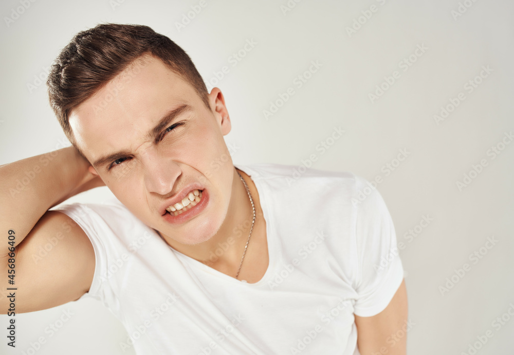 angry man in white t-shirt emotions displeasure annoyance studio angry man in white t-shirt emotions displeasure annoyance studio
