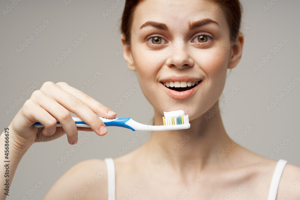 pretty woman in white t-shirt dental hygiene health care studio lifestyle pretty woman in white t-shirt dental hygiene health care studio lifestyle