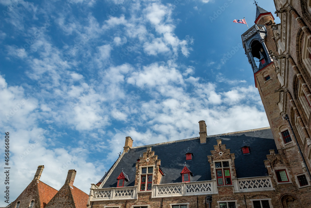 Beautiful roof and scenery sky, street view of old Bruges, Belgium, cloudy summer day