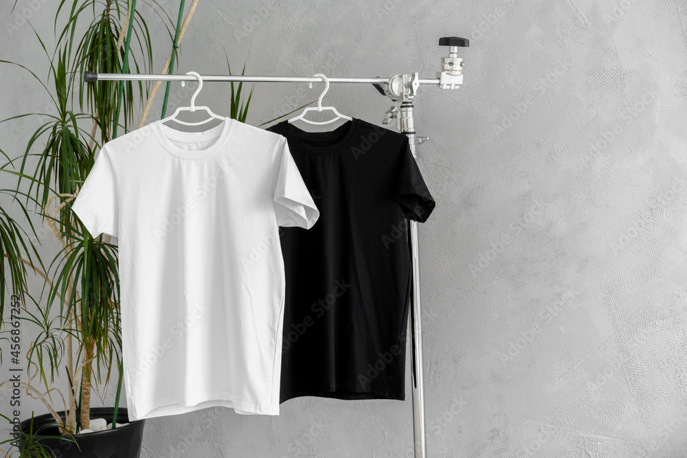 White and black T-shirts on hangers for design presentation White and black T-shirts on hangers for design presentation