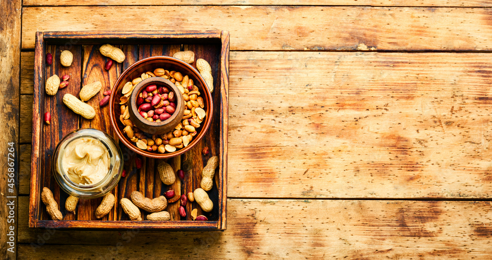 Homemade peanut butter on retro wooden table Homemade peanut butter on retro wooden table
