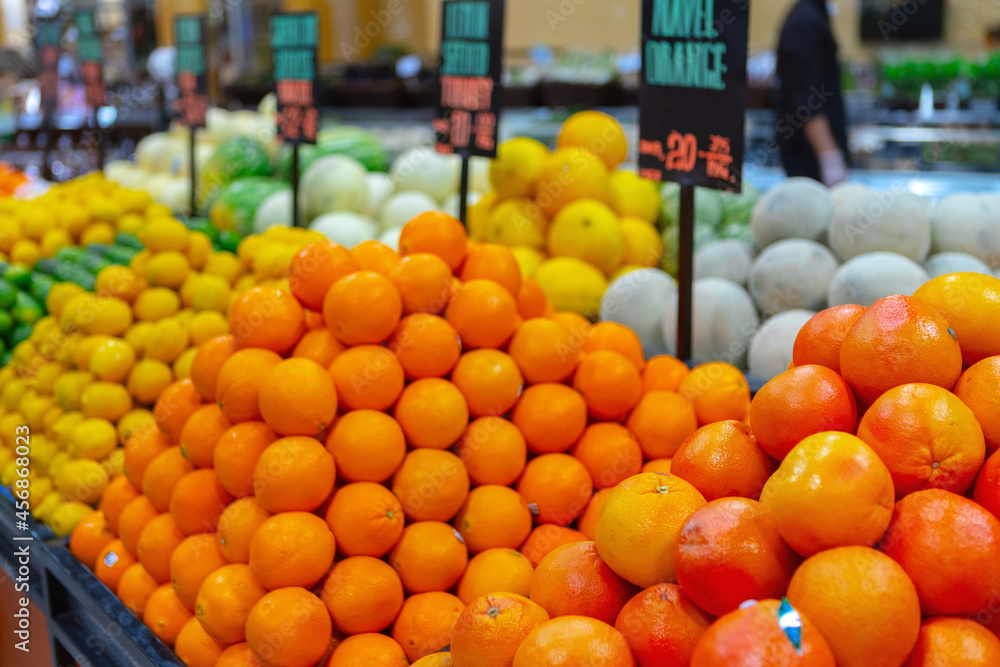 Fresh fruits oranges and lemons on shelf in supermarket