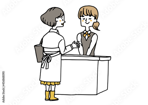 受付の人に話しかける女性