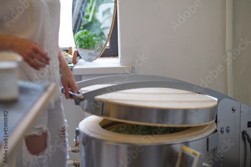 Φωτογραφία female potter put it into a kiln for firing
