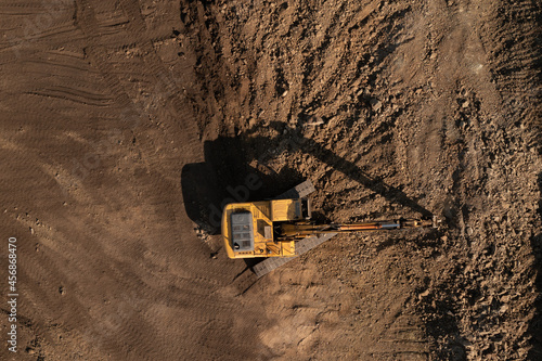 Overhead view of excavator doing earth works on a rocky surface