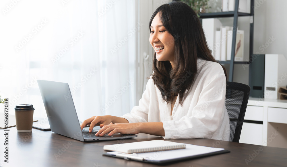 Young asian woman using Laptop with working creative at home office. Young asian woman using Laptop with working creative at home office.