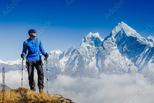 Hiker on the top in Himalayas mountains. Travel sport lifestyle concept