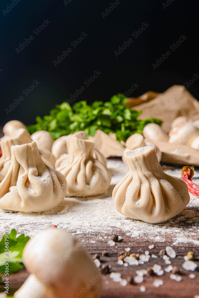 Fototapeta premium Georgian dumpling or Khinkali. Georgian homemade khinkali on wooden background.