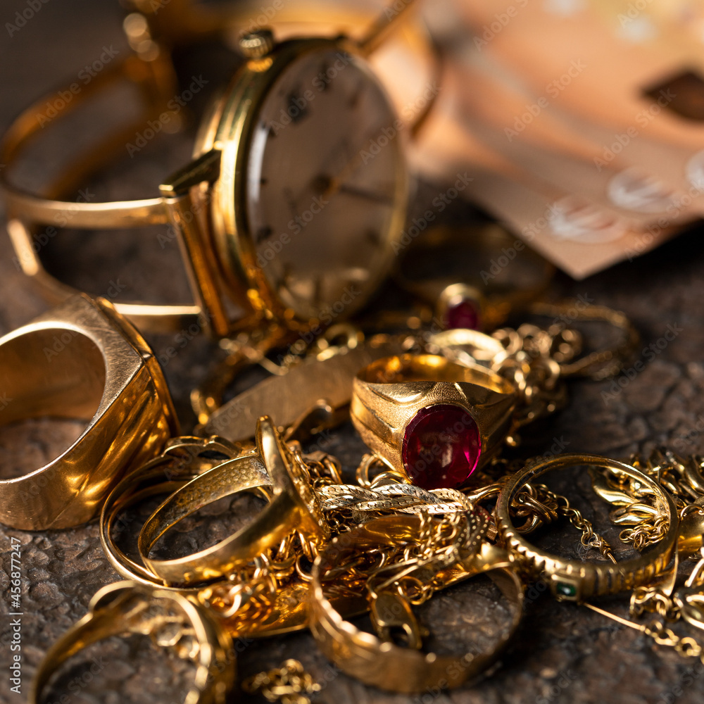 Old and broken jewelry and on Euro banknotes on dark background. Cash for gold concept. Old and broken jewelry and on Euro banknotes on dark background. Cash for gold concept.
