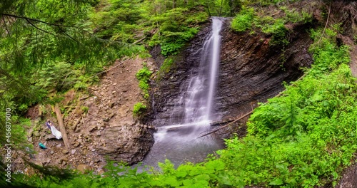  Ukraine, Mykulychyn, July 24, 2021: The popular Guk waterfall under the Synyak and Khomyak peaks in the Carpathians, many people come and even take pictures of weddings photo