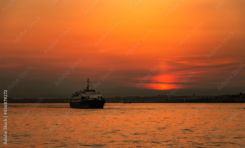 Fototapeta premium Ferry boat in Marmara sea near Istanbul coast. Sunset time