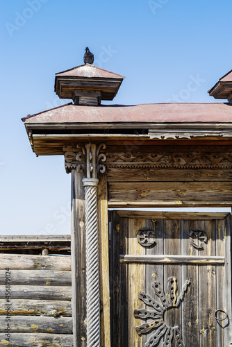 Fragment of old carved wooden gates of a country estate. Chelyabinsk region, Russia photo