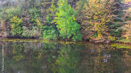Fototapeta Naklejka Na Ścianę i Meble -  Reflection of the autumn forest in the water of a deep lake.