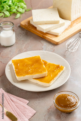 Sliced White Bread with kaya Jam. Coconut jam, also known as kaya jam, is a sweet spread made from a base of coconut milk, eggs and sugar. photo