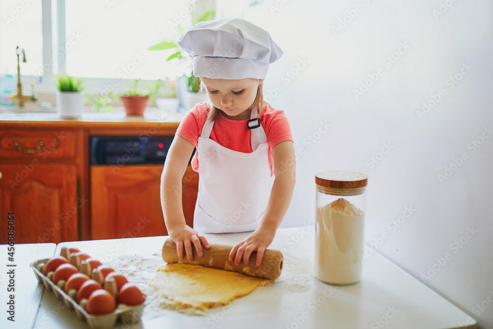 Adorable preschooler girl making cookies Adorable preschooler girl making cookies