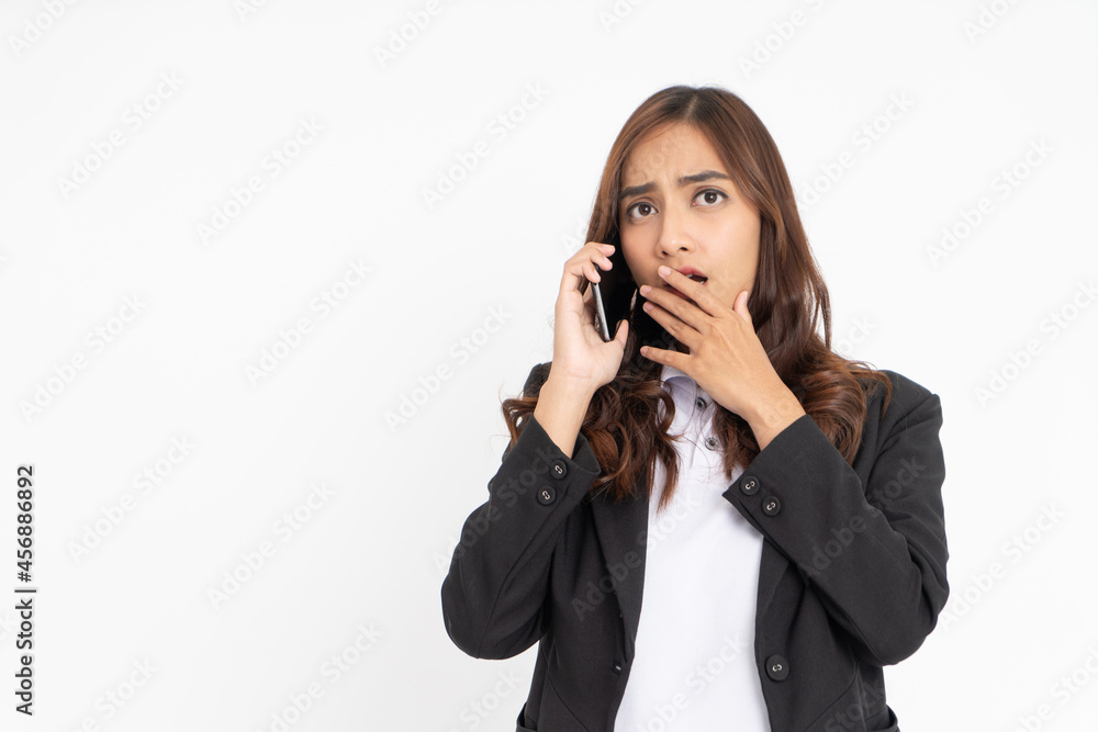 young asian businesswoman shocked and worried while making a phone call young asian businesswoman shocked and worried while making a phone call