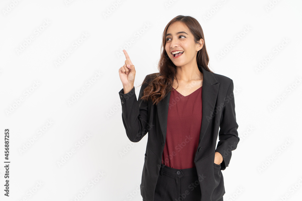 Excited young businesswoman with hand gesture pointing sideways with copyspace Excited young businesswoman with hand gesture pointing sideways with copyspace