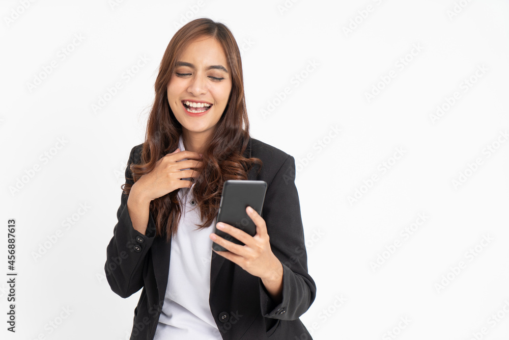 beautiful asian businesswoman smiling when looking at mobile phone screen with space beautiful asian businesswoman smiling when looking at mobile phone screen with space