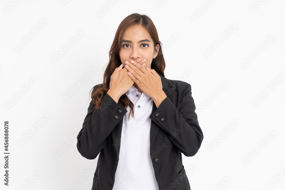 businesswoman covering her mouth with both hands businesswoman covering her mouth with both hands