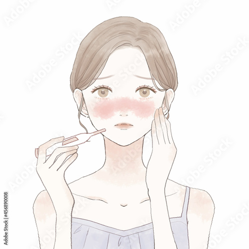 体温計で熱を測る女性