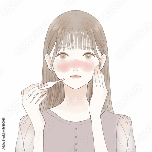 体温計で熱を測る女性