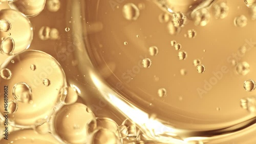 Super Slow Motion Shot of Moving Oil Bubbles on Golden Background at 1000fps. photo