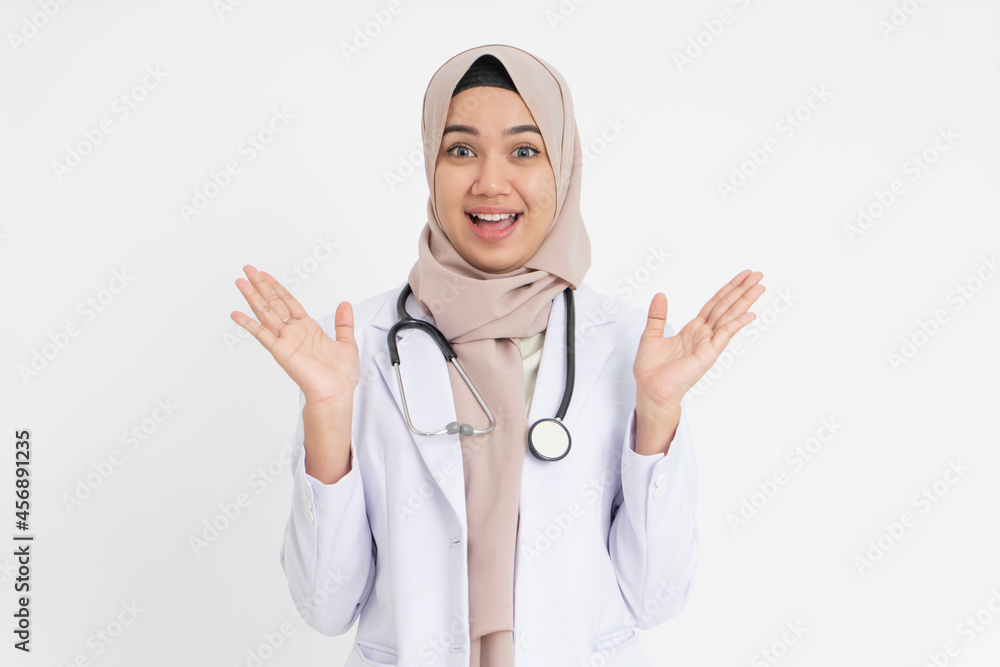 veiled female doctor raising hand on chin when smiling happily veiled female doctor raising hand on chin when smiling happily