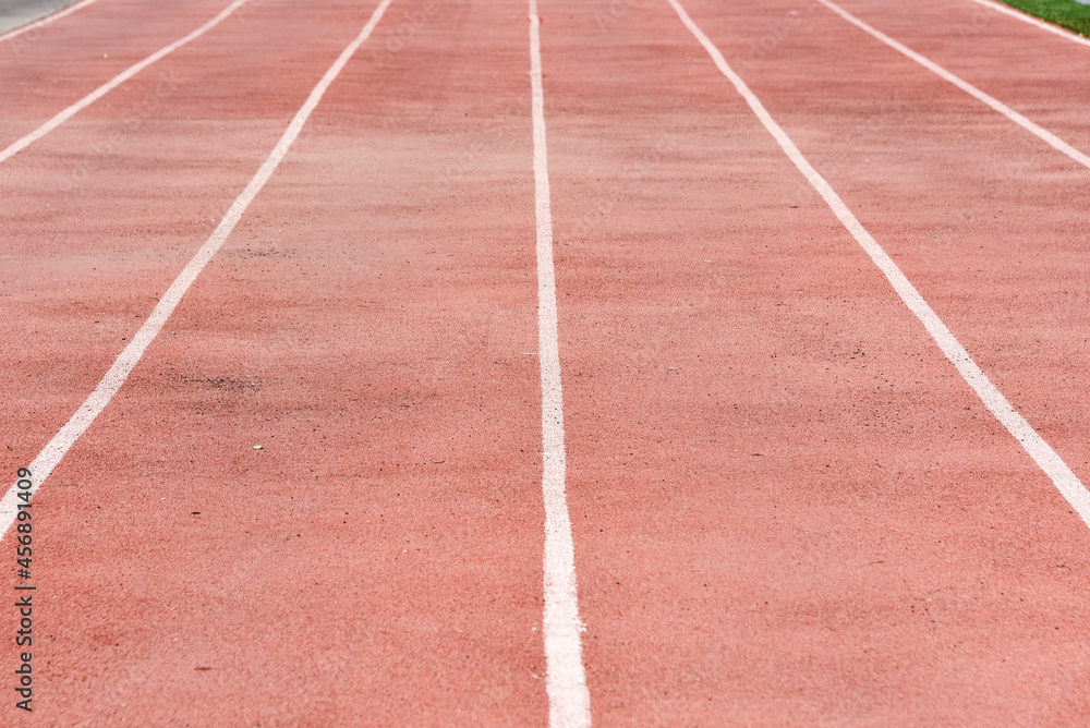 Red running tracks close-up at the stadium. Running love concept