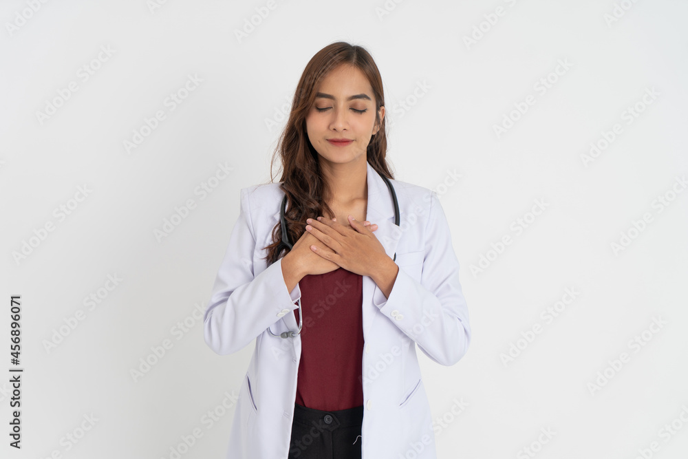 beautiful doctor in white uniform holding chest and eyes closed with patient expression beautiful doctor in white uniform holding chest and eyes closed with patient expression