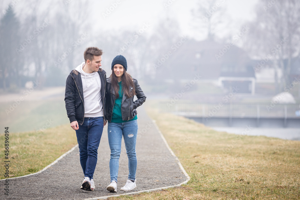 Young couple spending time together at Lake Gebart on a foggy winter day in Zalaegerszeg, Hungary Young couple spending time together at Lake Gebart on a foggy winter day in Zalaegerszeg, Hungary