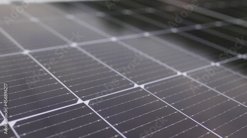 Photovoltaic solar panel extreme close up. Close-up of modern photovoltaic solar battery panels. Rows of sustainable energy solar panels installed on terrace. Solar panels on roof top. Panels at home.