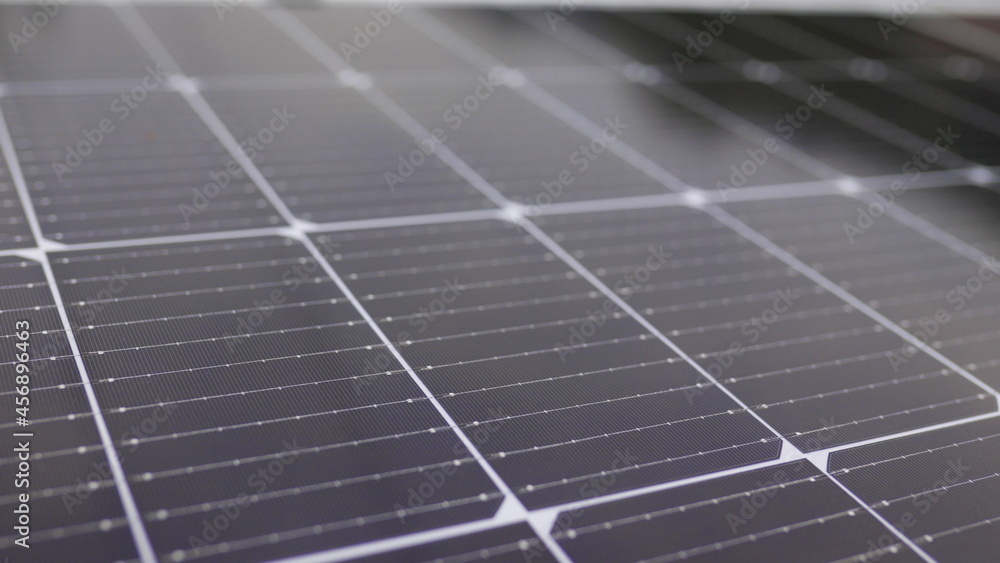 Photovoltaic solar panel extreme close up. Close-up of modern photovoltaic solar battery panels. Rows of sustainable energy solar panels installed on terrace. Solar panels on roof top. Panels at home.