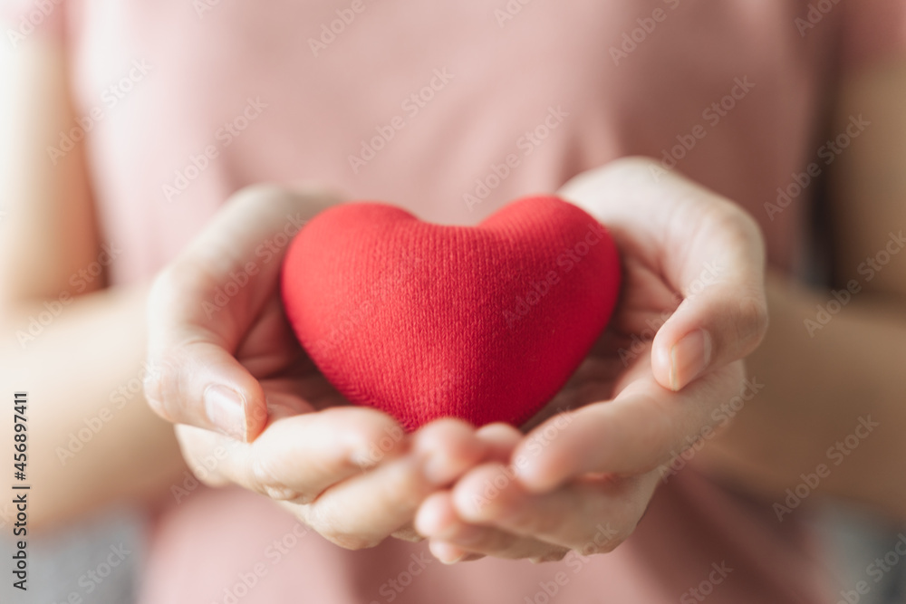 Woman holding red heart, love, health insurance, donation, happy charity volunteer, world mental health day, world heart day, valentine's day Woman holding red heart, love, health insurance, donation, happy charity volunteer, world mental health day, world heart day, valentine's day