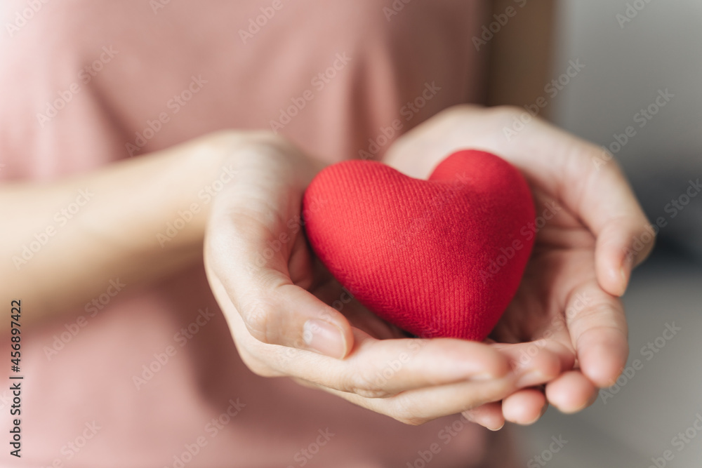 Woman holding red heart, love, health insurance, donation, happy charity volunteer, world mental health day, world heart day, valentine's day Woman holding red heart, love, health insurance, donation, happy charity volunteer, world mental health day, world heart day, valentine's day