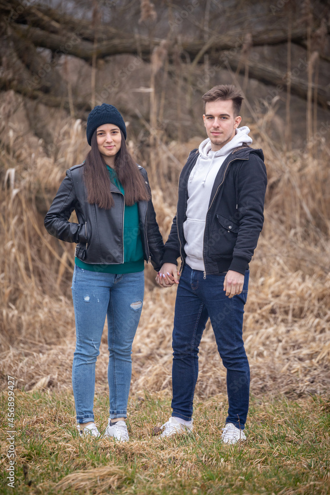 Fototapeta premium Young couple standing in nature on a winter day