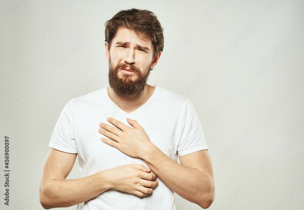 Man in a white t-shirt hand gestures anger close-up Man in a white t-shirt hand gestures anger close-up