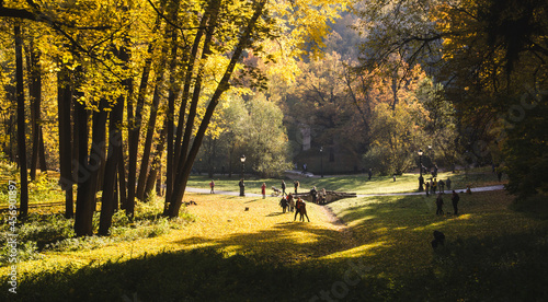 Beautiful autumn landscape. In the background people are walking in the park