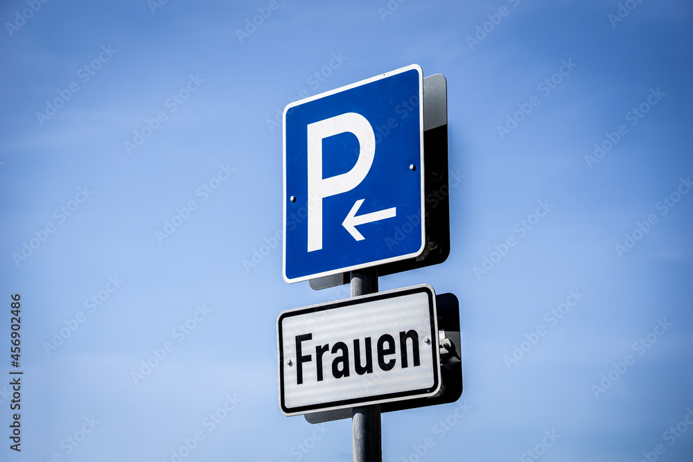 Parking where is written the word: Woman. Place for special parking slots for woman Parking where is written the word: Woman. Place for special parking slots for woman