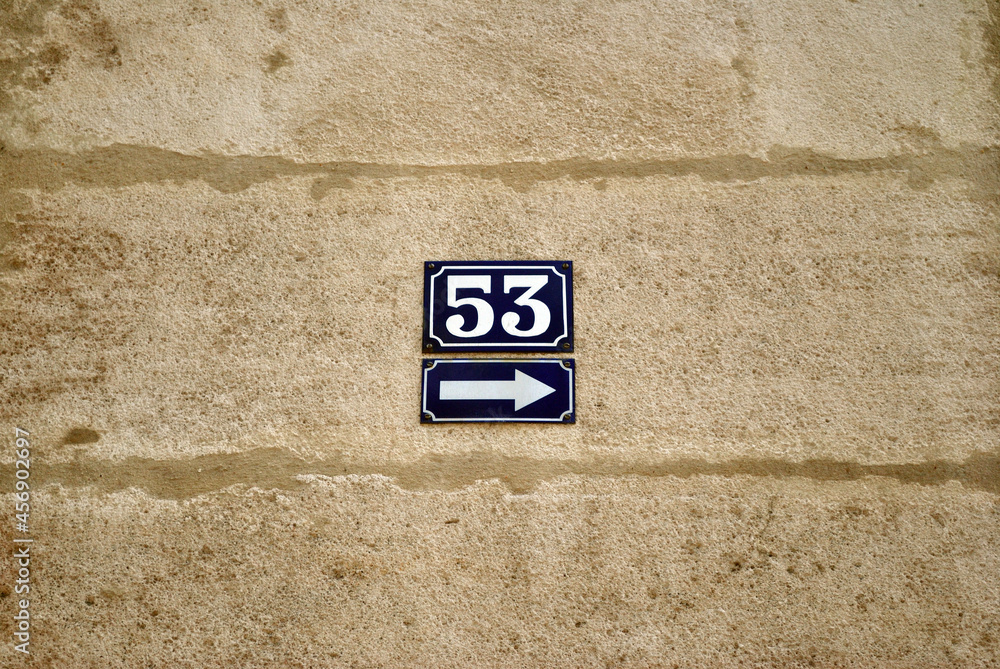 Close Up of Blue Ceramic Plaques on Stone Wall with Arrow & Number 53 Close Up of Blue Ceramic Plaques on Stone Wall with Arrow & Number 53