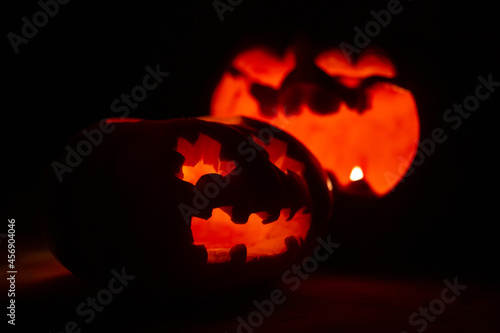 carved pumpkin faces for halloween. pumpkins glow on a black background