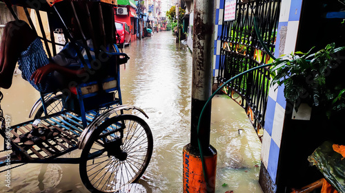 A man pulled rickshaw stands on the road which accumulates with water after heavy rain fall in kolkata on September 14, 2021.